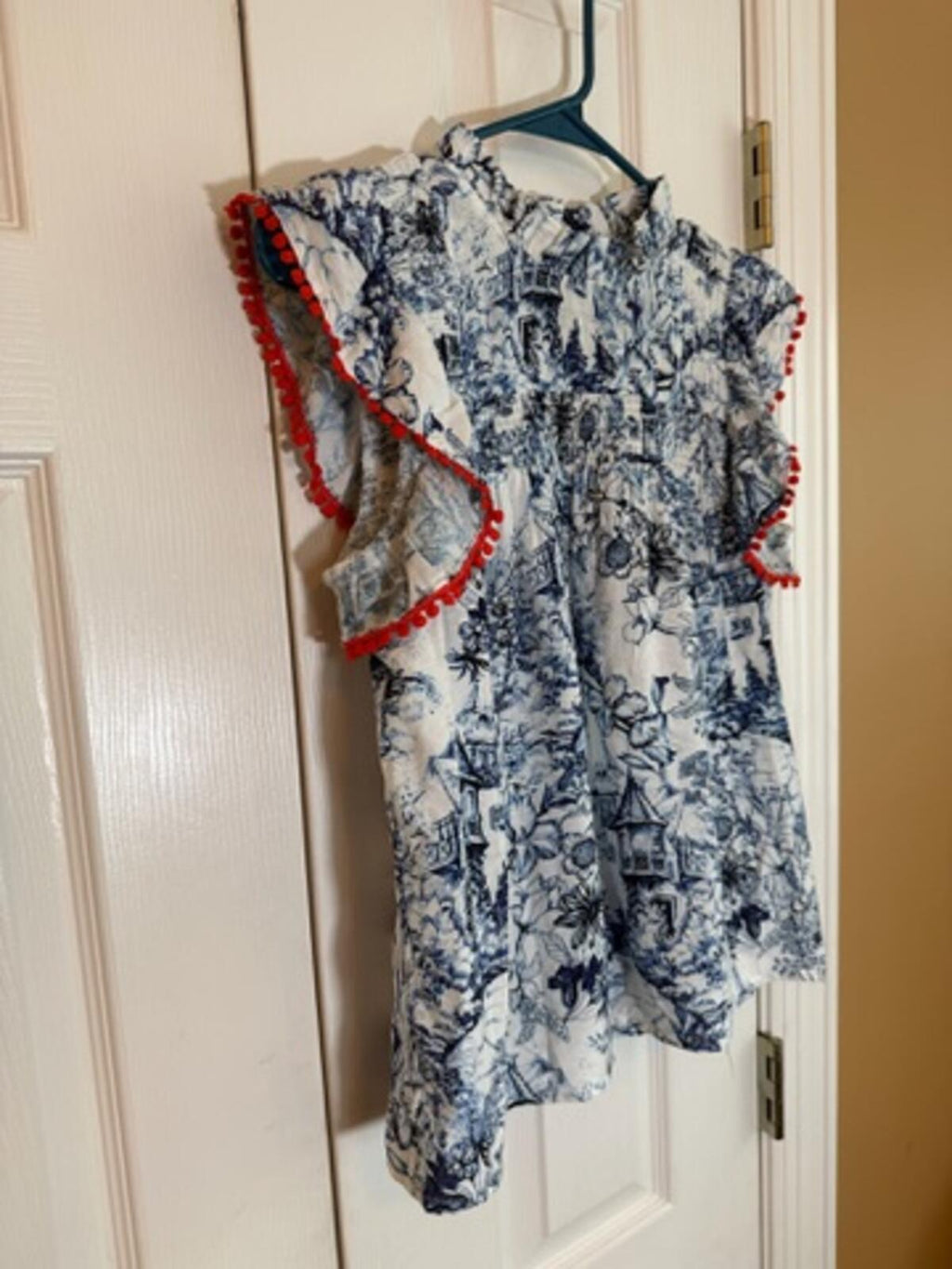 Sleeveless Printed Blouse with Ruffle and Red Trim Detail