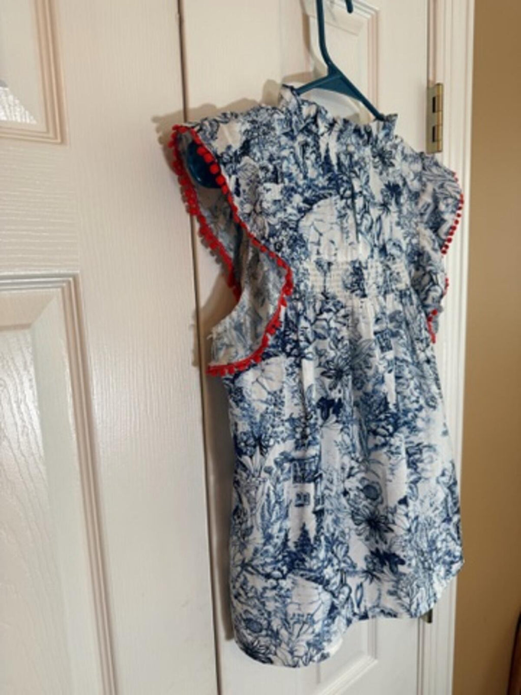 Sleeveless Printed Blouse with Ruffle and Red Trim Detail