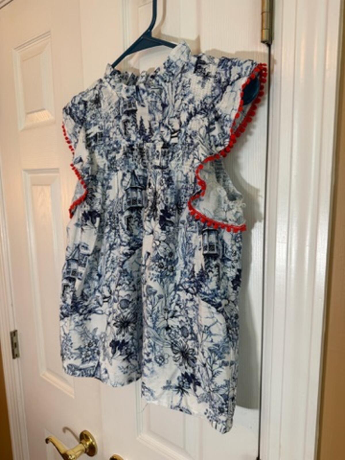 Sleeveless Printed Blouse with Ruffle and Red Trim Detail